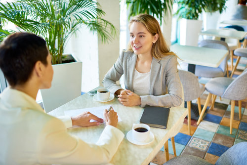 Two Business Women Meeting at Coffee Break